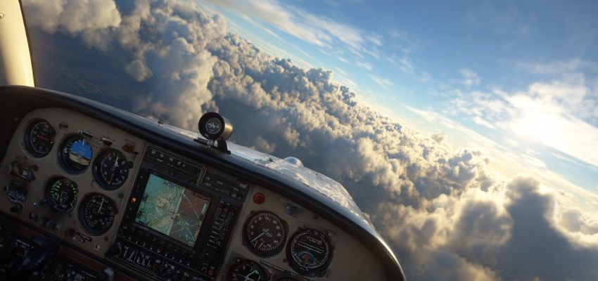 Pilot cockpit view above clouds following visual flight rules in clear daylight conditions