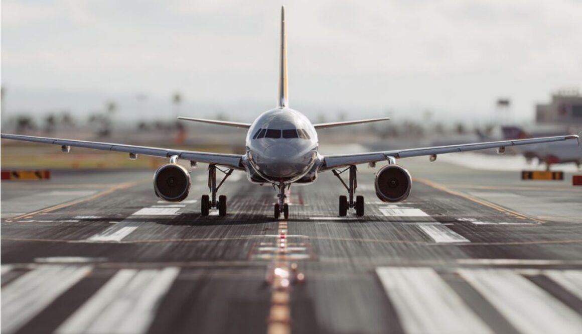 Head-on view of a passenger airplane taxiing down the runway centerline, ready for departure from the airport