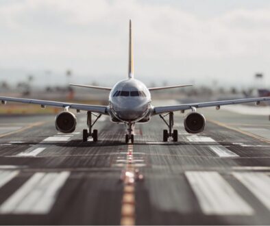 Head-on view of a passenger airplane taxiing down the runway centerline, ready for departure from the airport